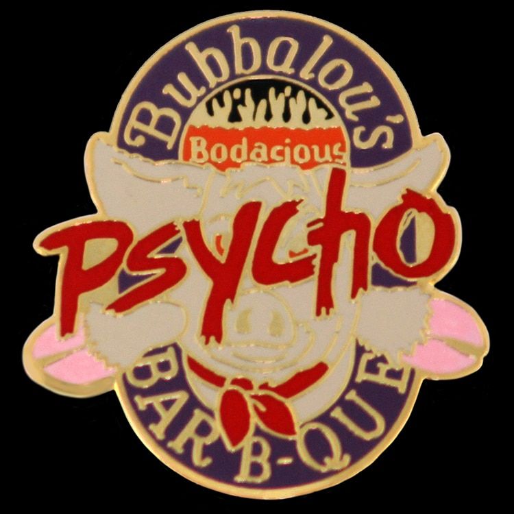 Cloisonne hard enamel lapel pin with a mascot figure in red, tan and purple enamel between raised gold metal walls.