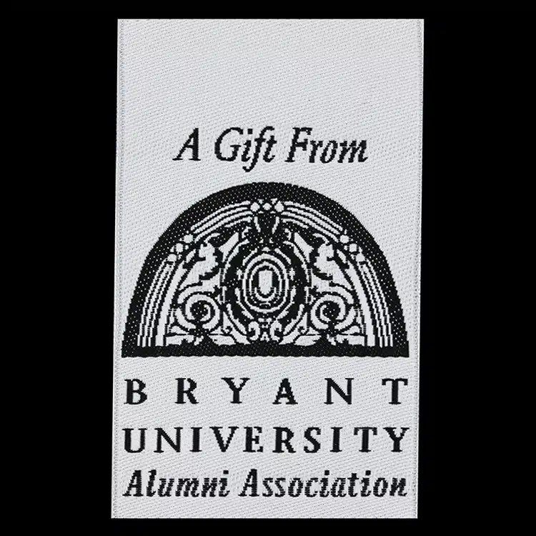 A Gift From Bryant University Alumni Association woven label with an archway graphic, black lettering on white.