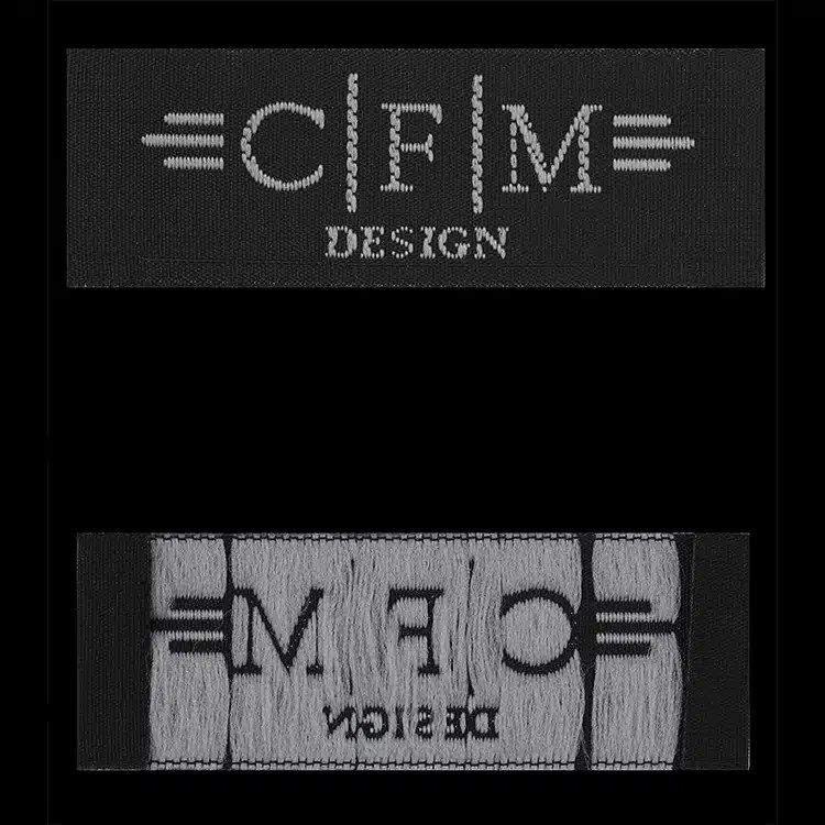 CFM Design woven labels shown front and back, white lettering on black.