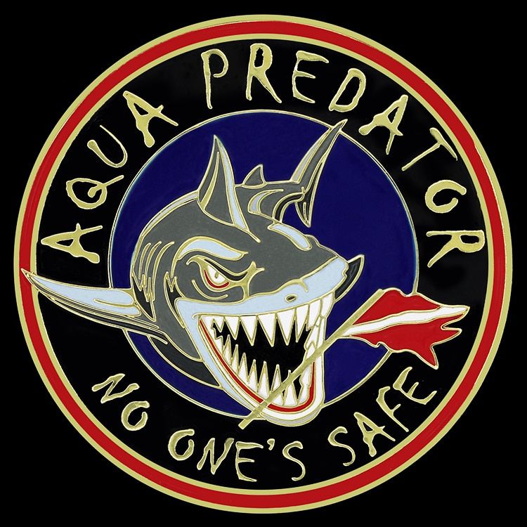 Round challenge coin with an Aqua Predator shark design, raised gold lettering reading No One's Safe, and black, blue, red and grey enamel.