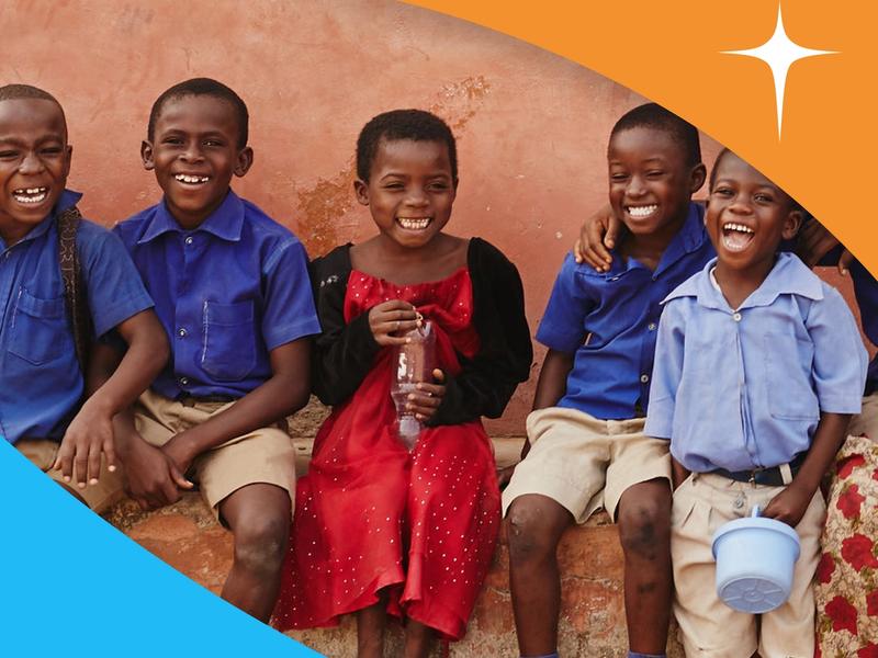 Image of smiling children with the World Vision's logo