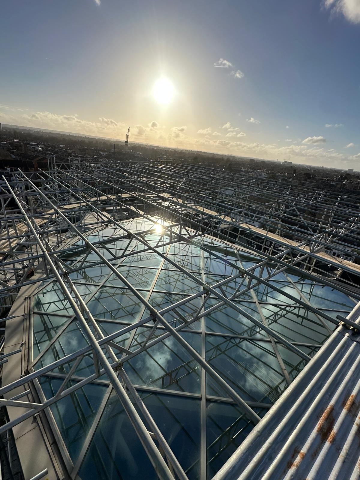 Scaffold deck built over a glass atrium roof, seen from above