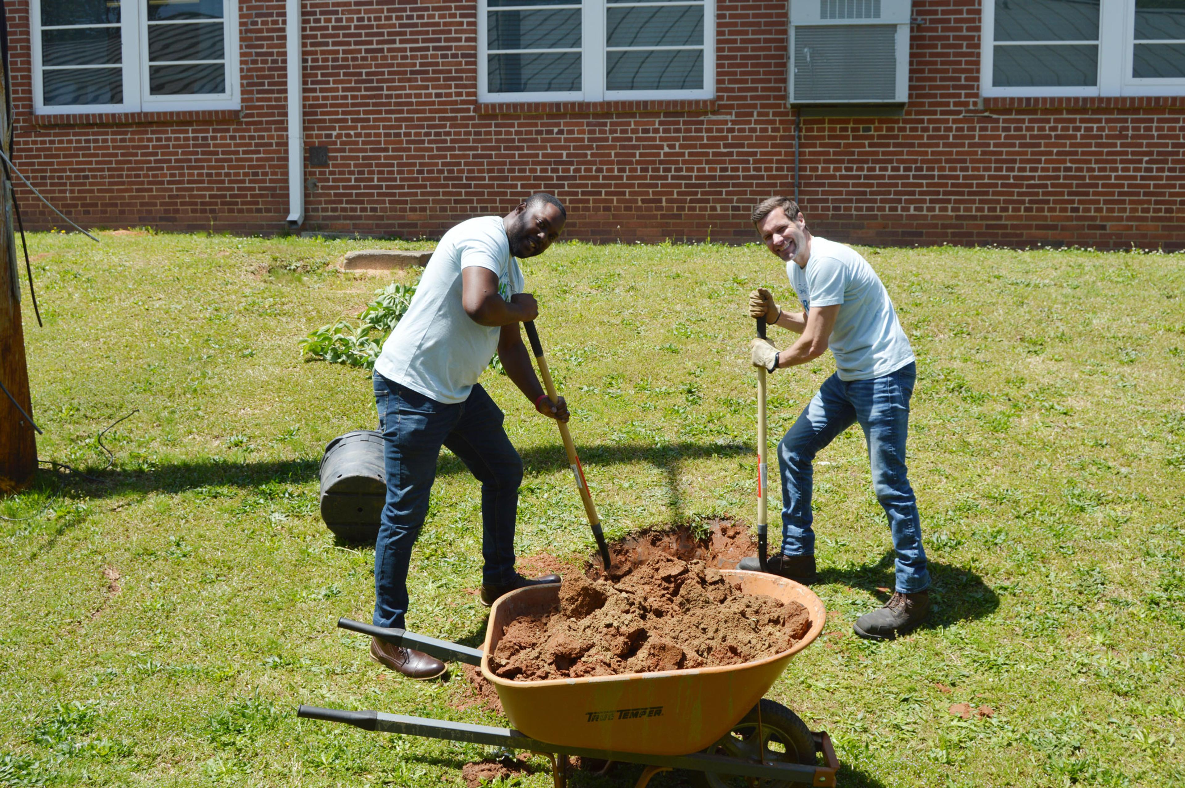 Two men shoveling dirt