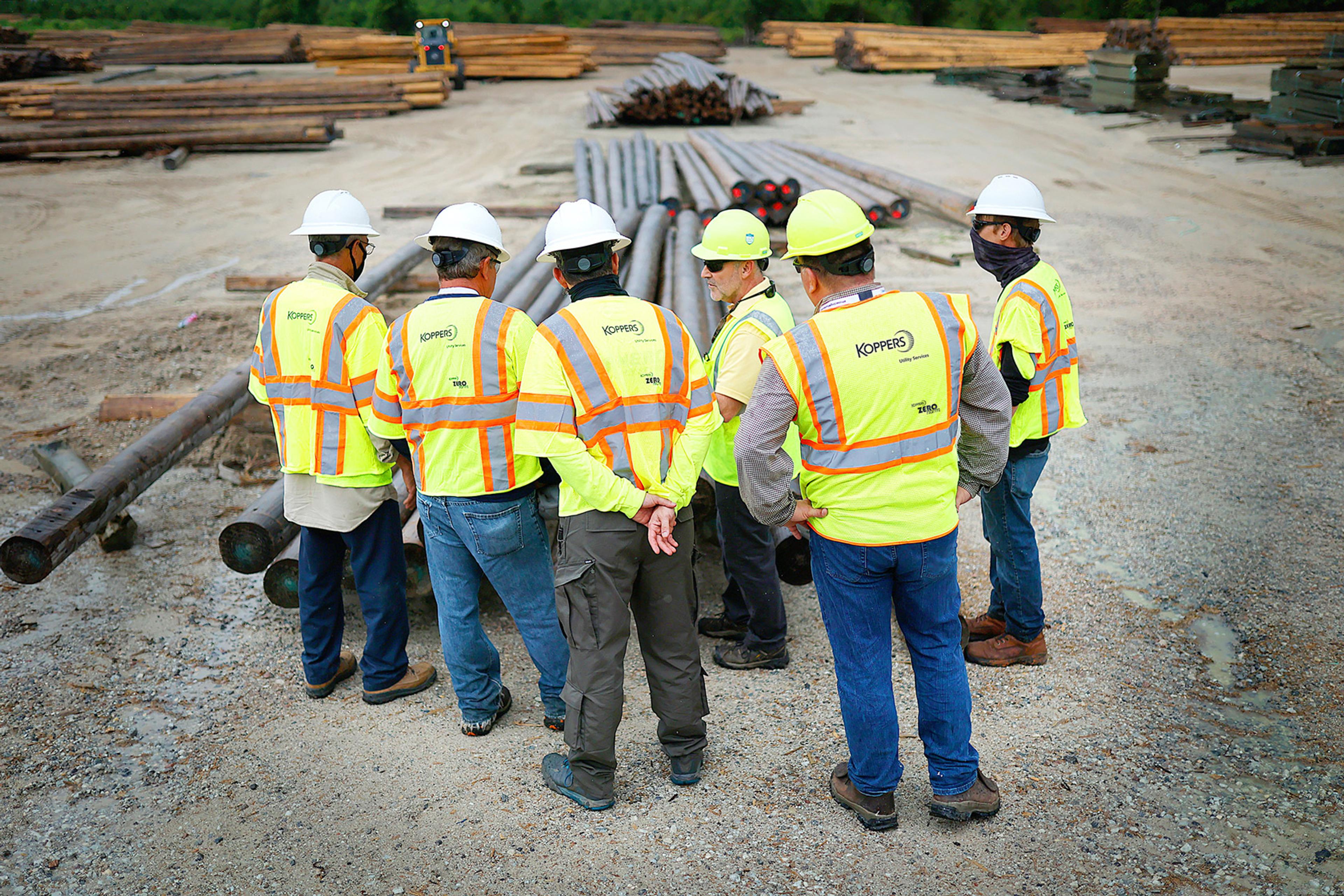 Koppers employees with safety vests and hard hats