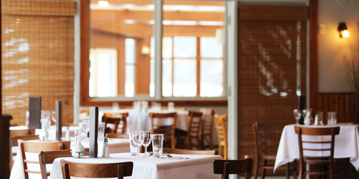 Warm interior of a European restaurant with tables set for service