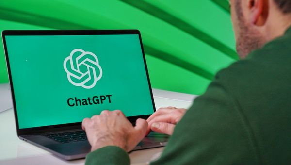 Person typing on a laptop that shows the ChatGPT logo