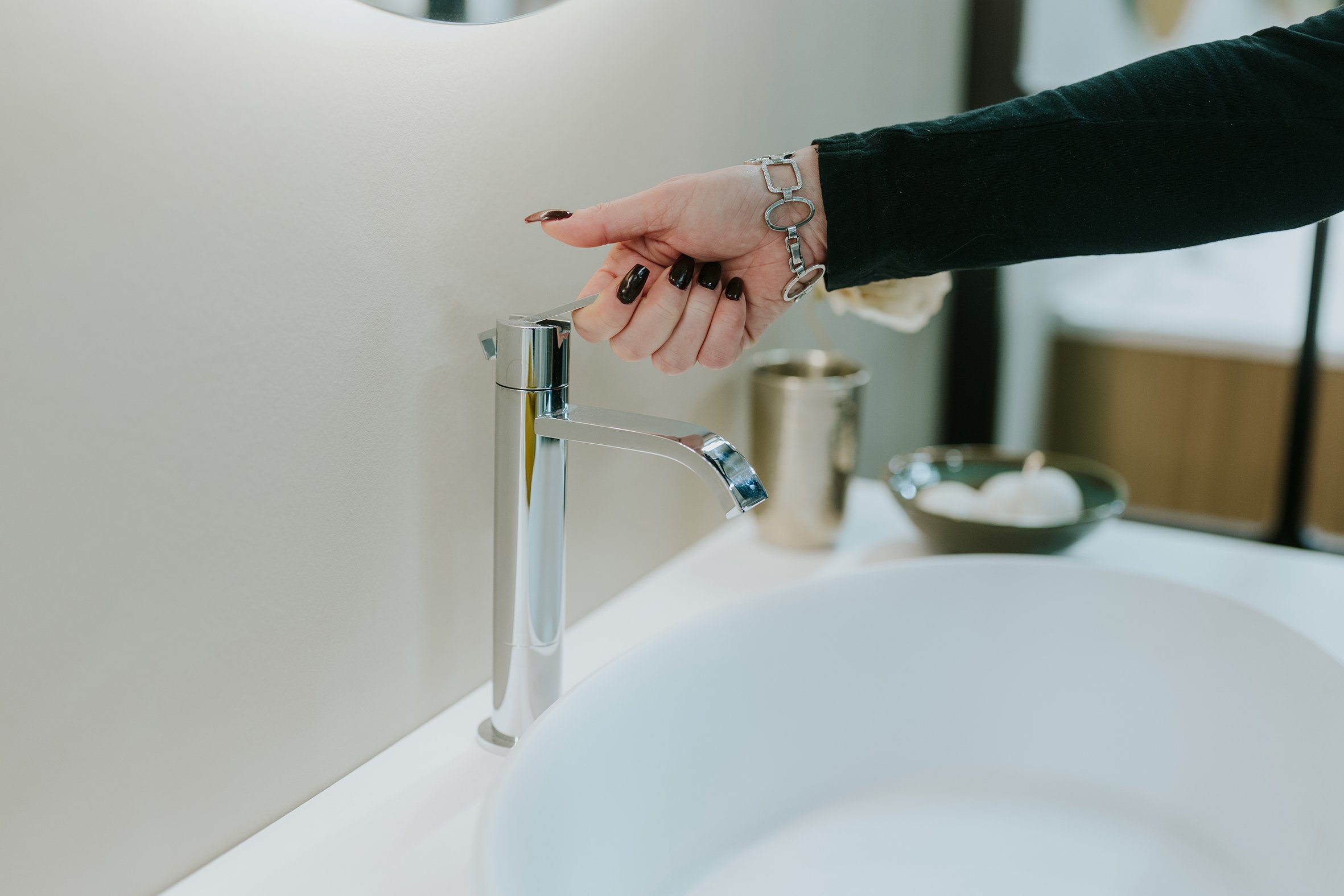Close-up of hand using modern bathroom tap in Spark Vision office