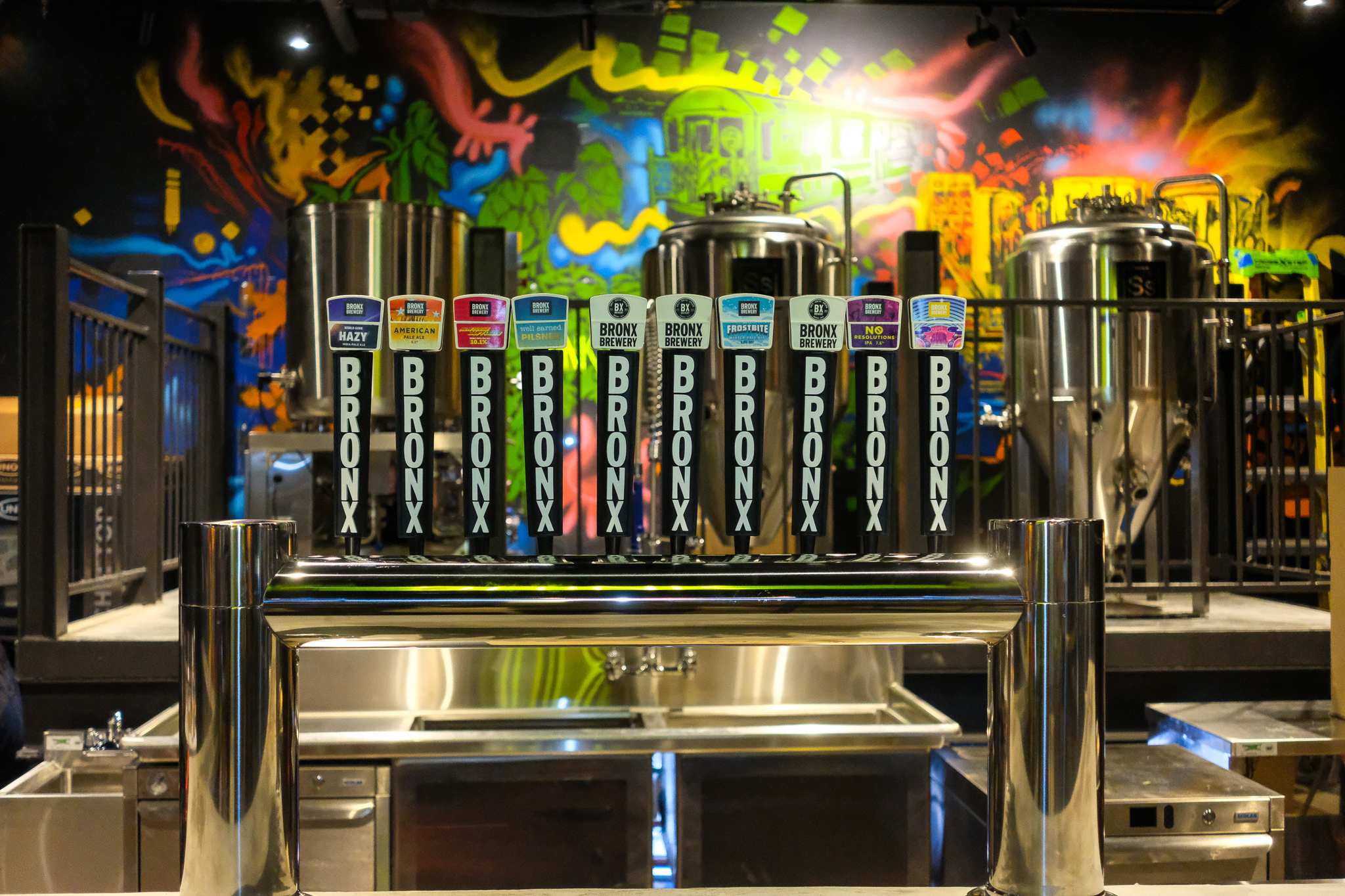 The Bronx Brewery taps with a colorful mural in the background