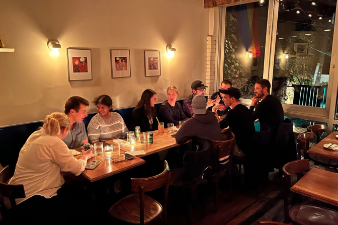 A photo of several Linear employees sitting around a table