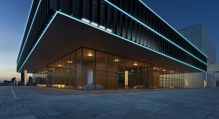 A modern commercial building at dusk lit by teal linear lighting