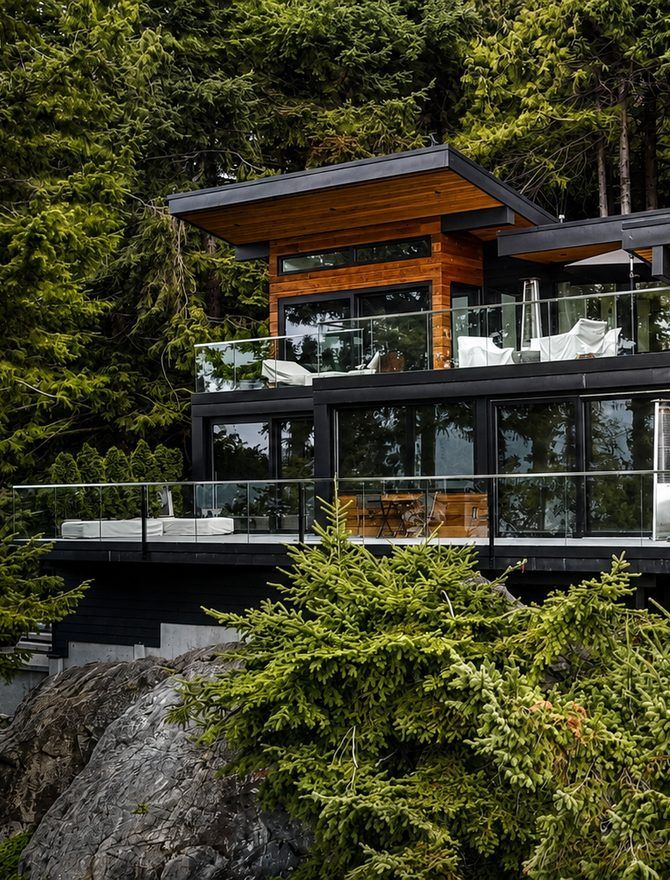 A modern glass and timber house set among trees
