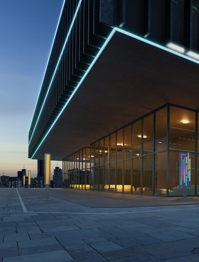 A modern commercial building at dusk lit by teal linear lighting