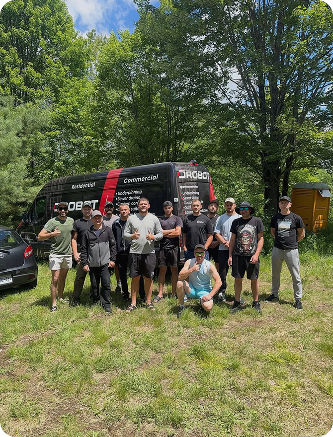 The Drobot Construction crew standing in front of a branded work van