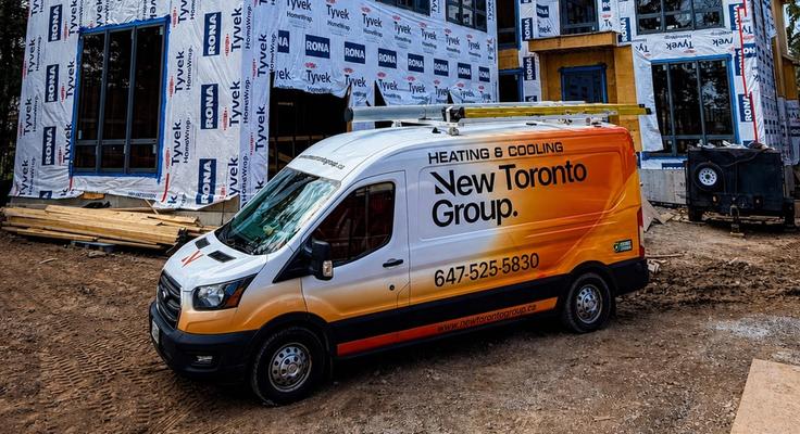 A New Toronto Group heating and cooling van outside a house under construction