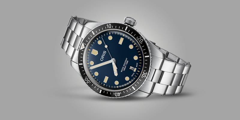 Oris Diver 65 with blue dial on bracelet laying on its side