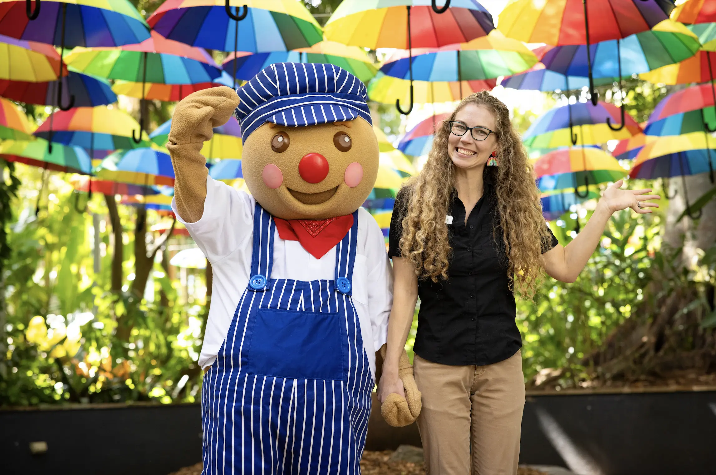 Ginger bread mascot holds hands with smiling woman