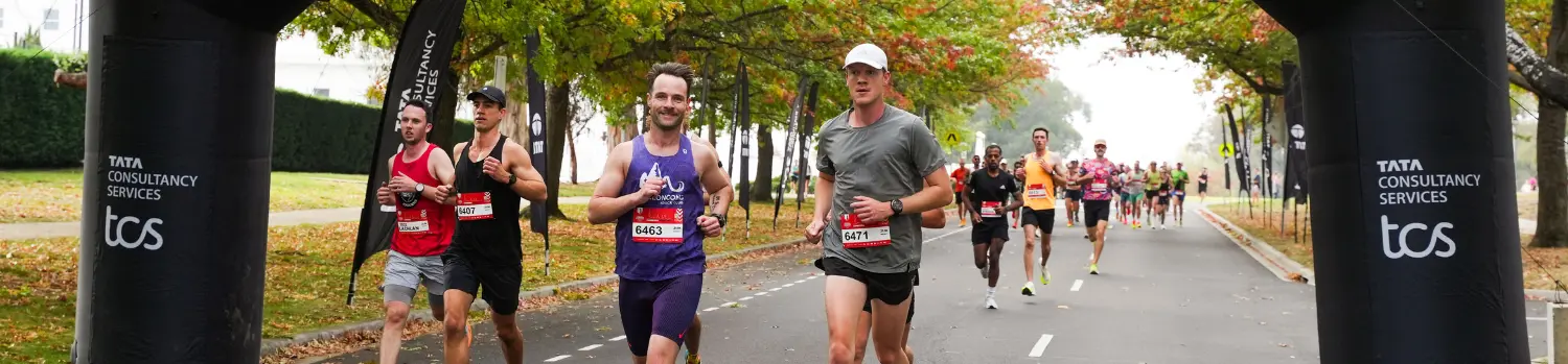 Young man running in blue singlet and backwards cap