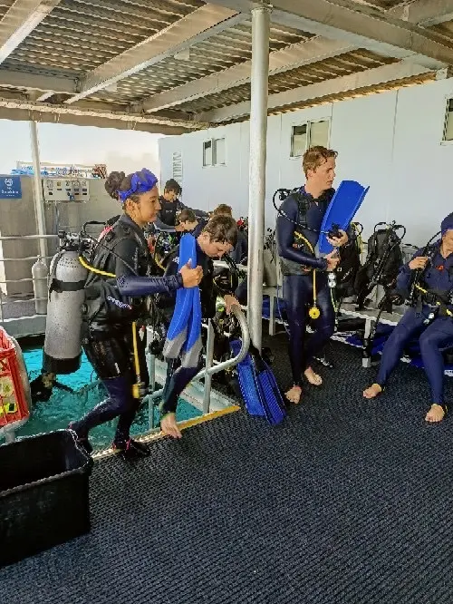 Make-A-Wish wish kid Sam finishing dive with family at Hamilton Island