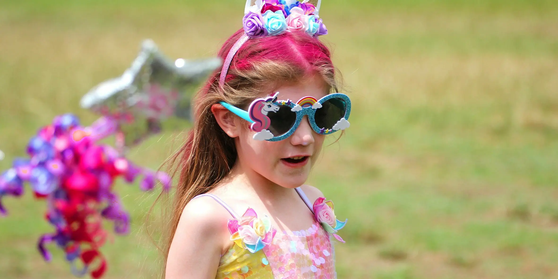 Make A Wish Australia Children's Charity - Abigail on her wish dressed up holding a star balloon