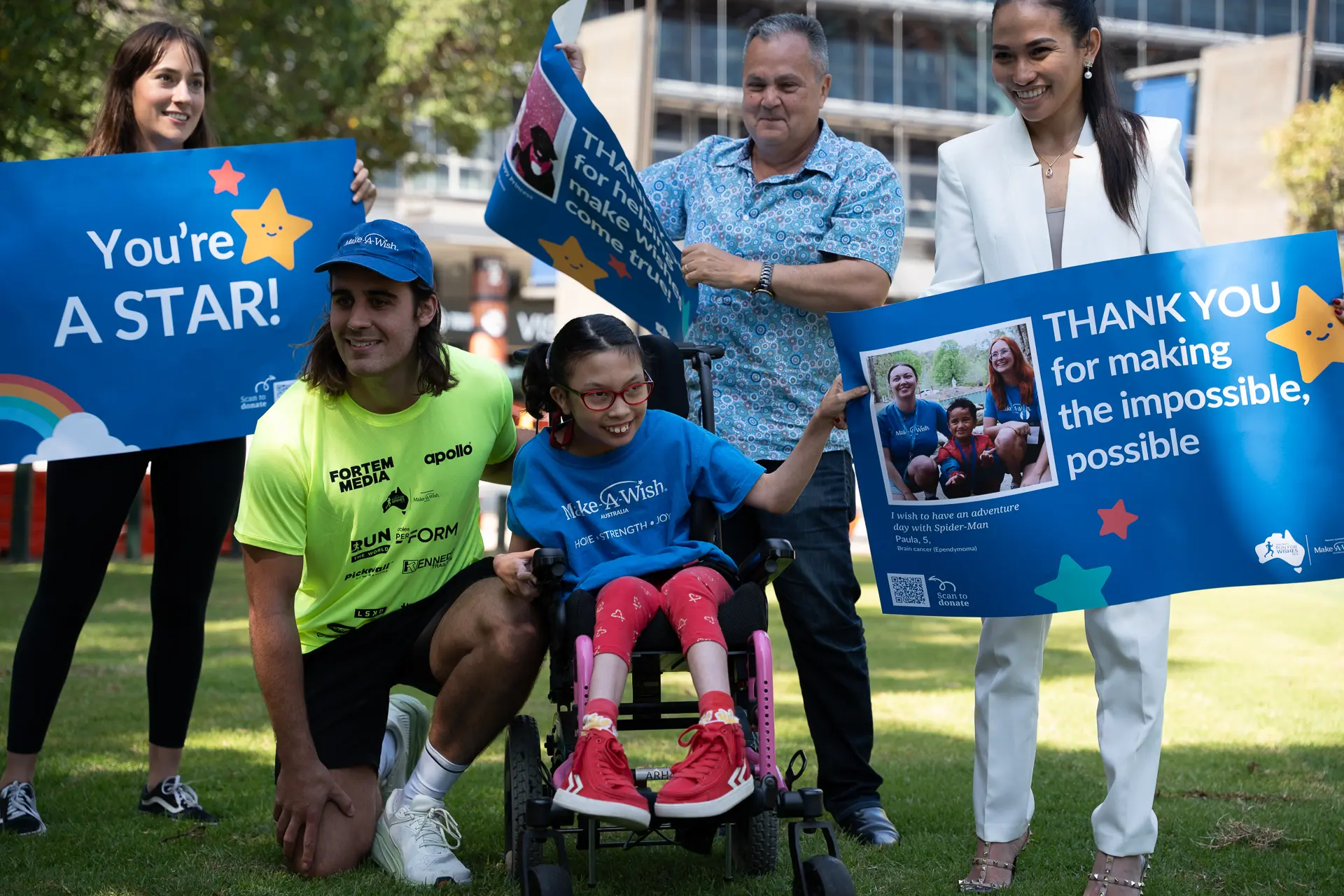 Smiling man with wish child surrounded by family