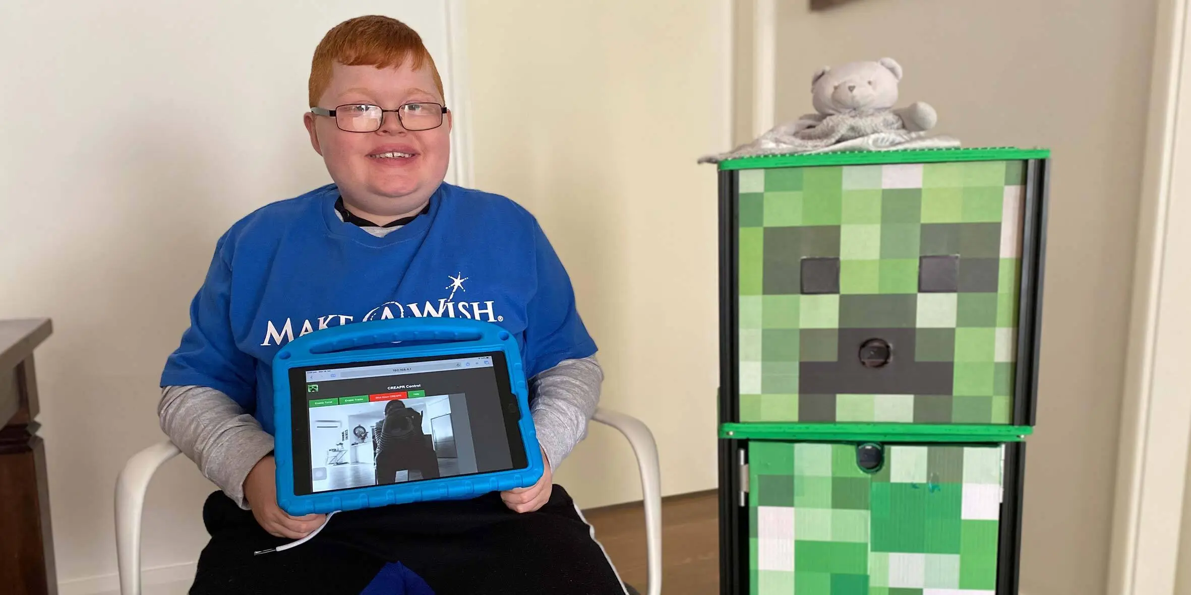 Make-A-Wish Australia wish kid Charlie sat with his robot