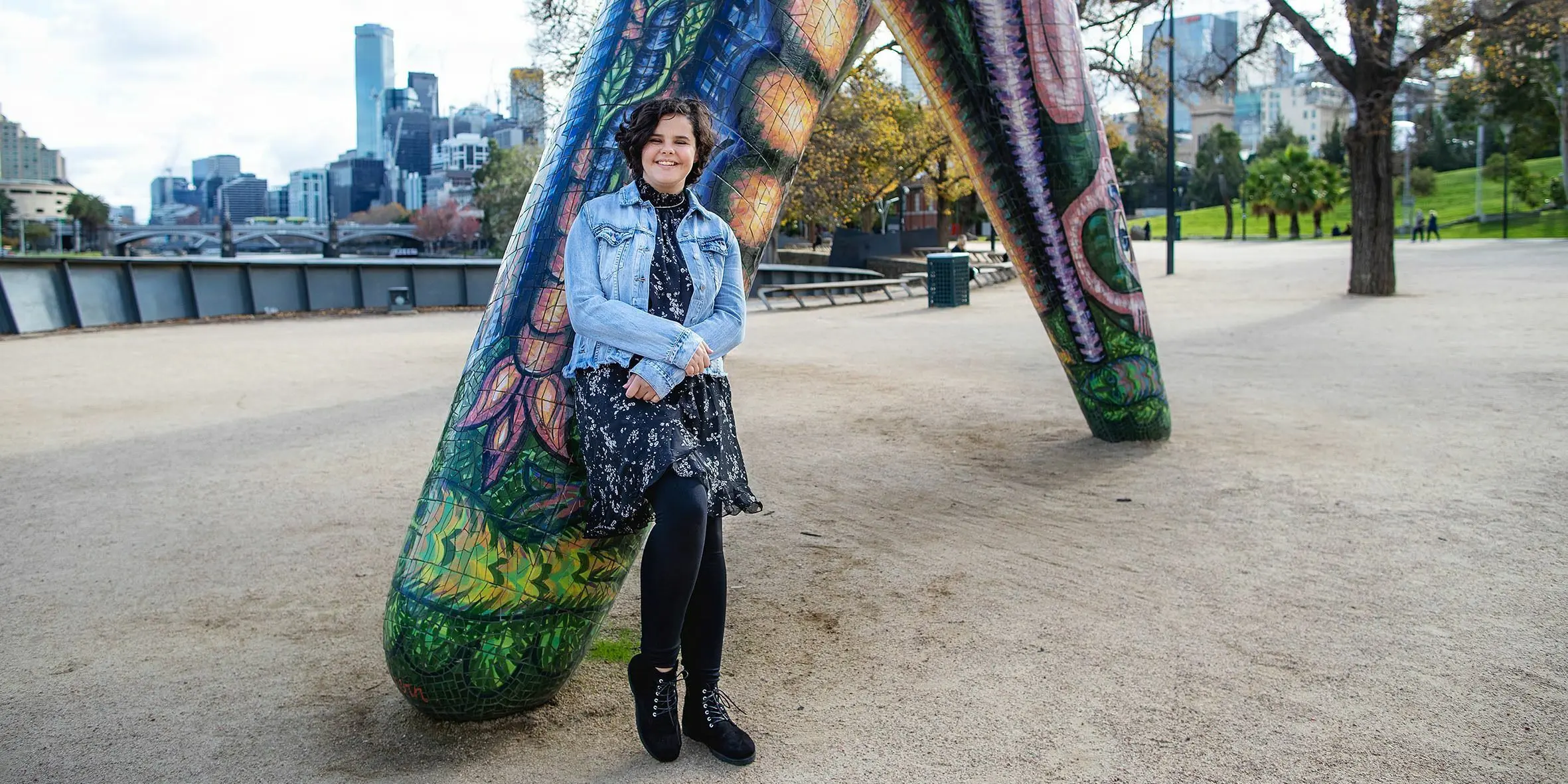 Make-A-Wish Australia wish kid Chelsea standing on the bank of river in Melbourne