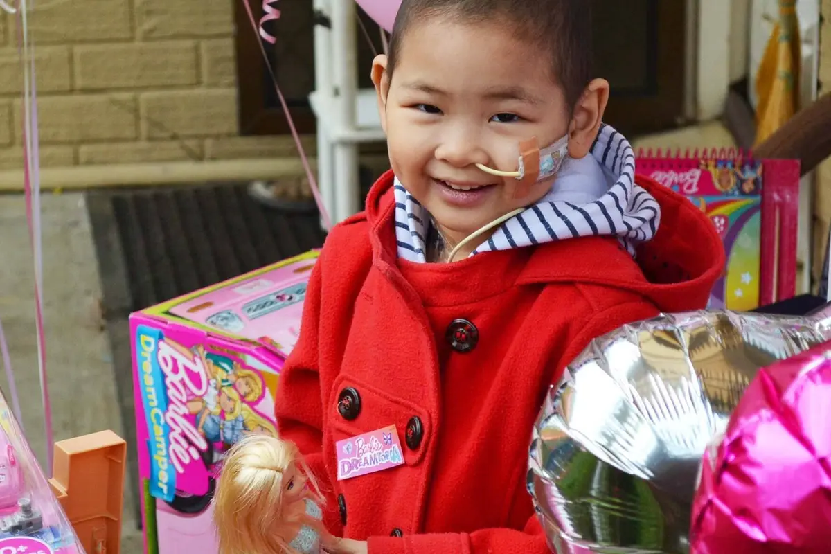 Kids Charity Make-A-Wish wish kid Maple with her Barbies