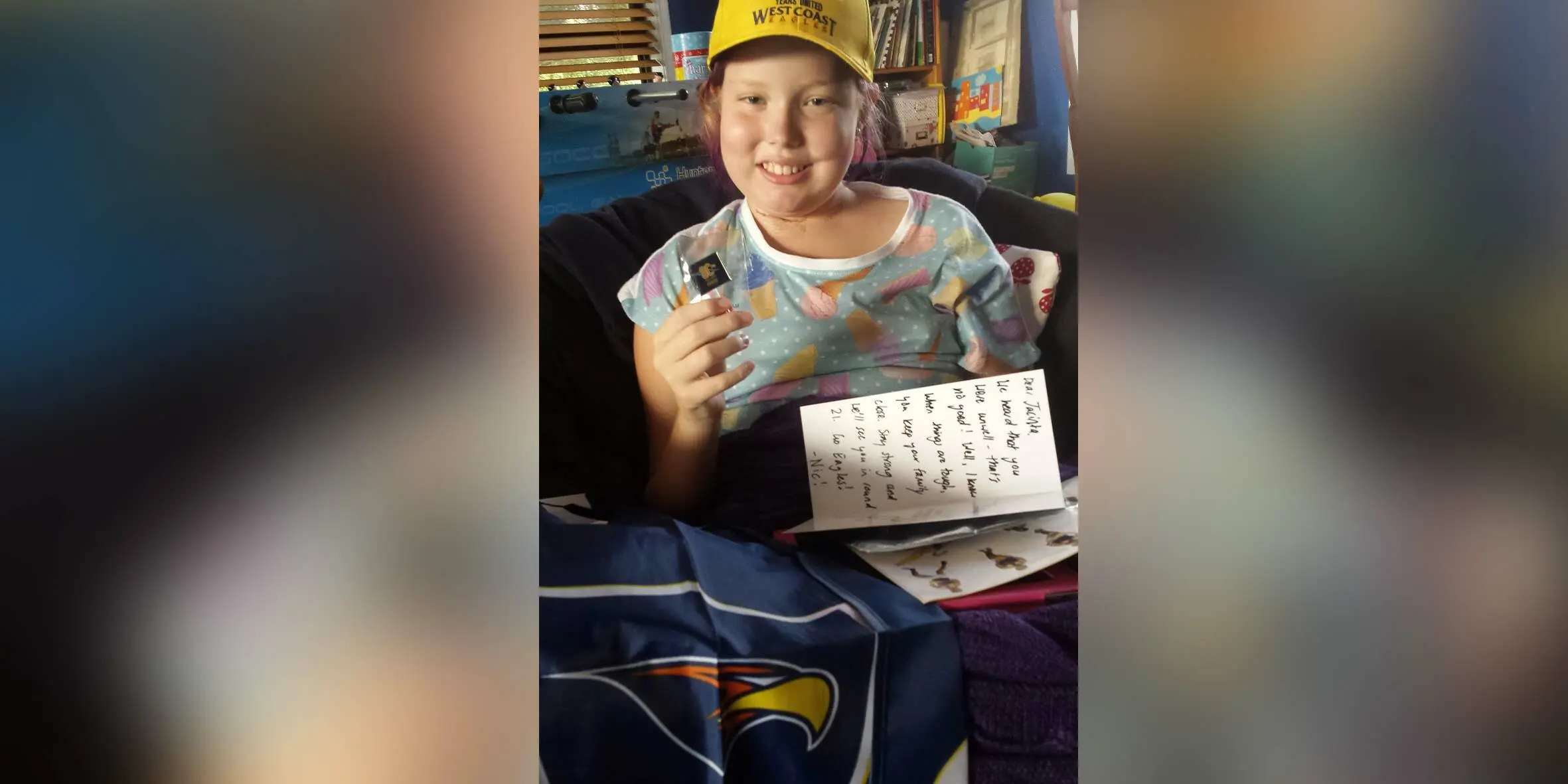 Make-A-Wish Australia wish kid Jacinta holding the letter sent to her by Nic Naitanui