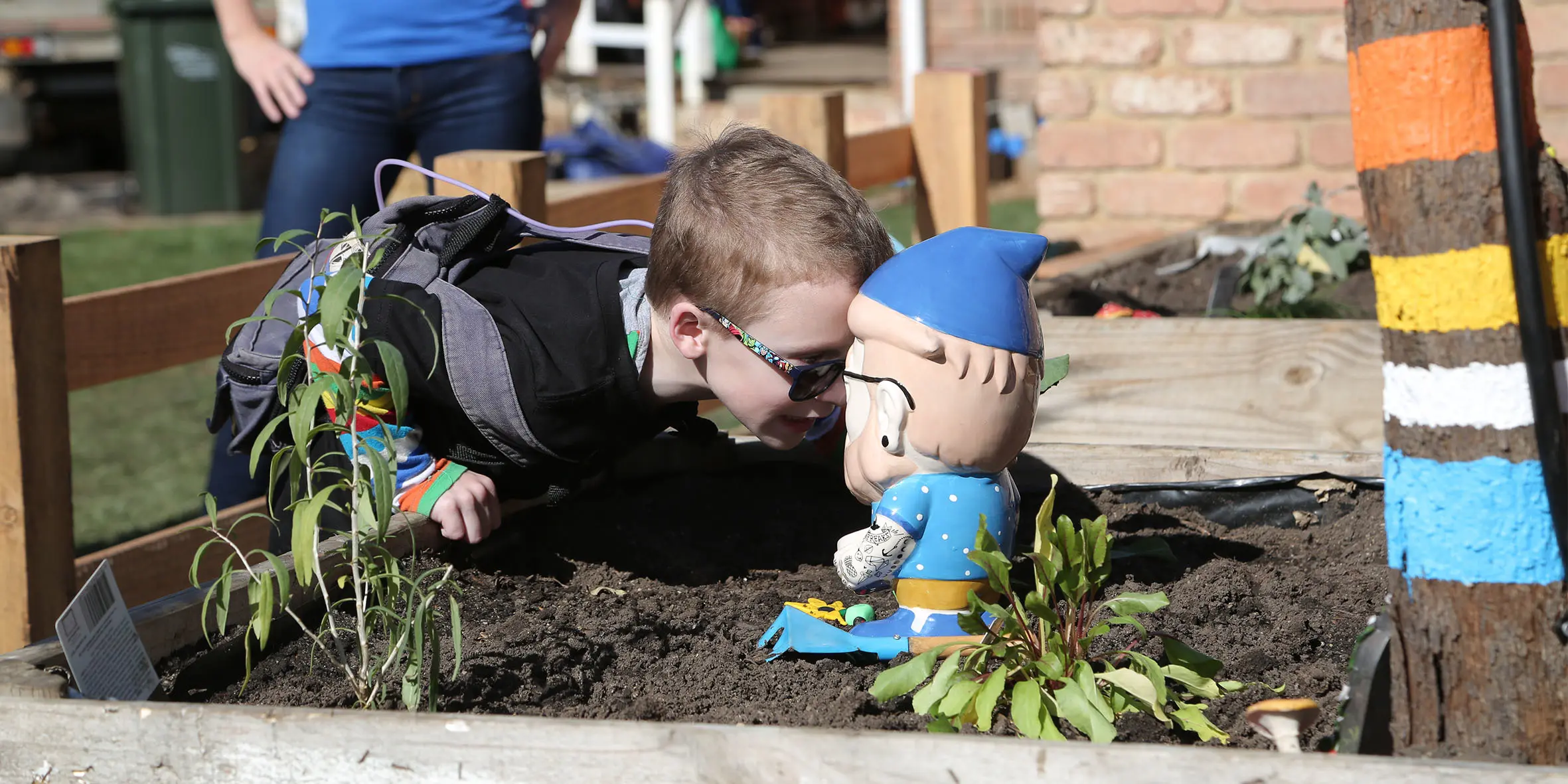 Make A Wish Australia Children's Charity - Noah on his wish in the garden with a knome