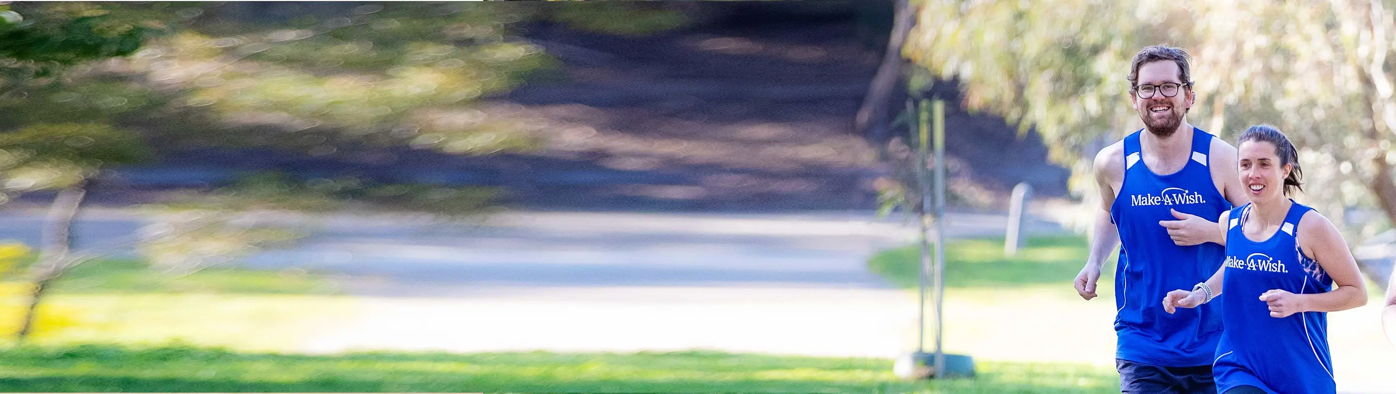 Young man running in blue singlet and backwards cap