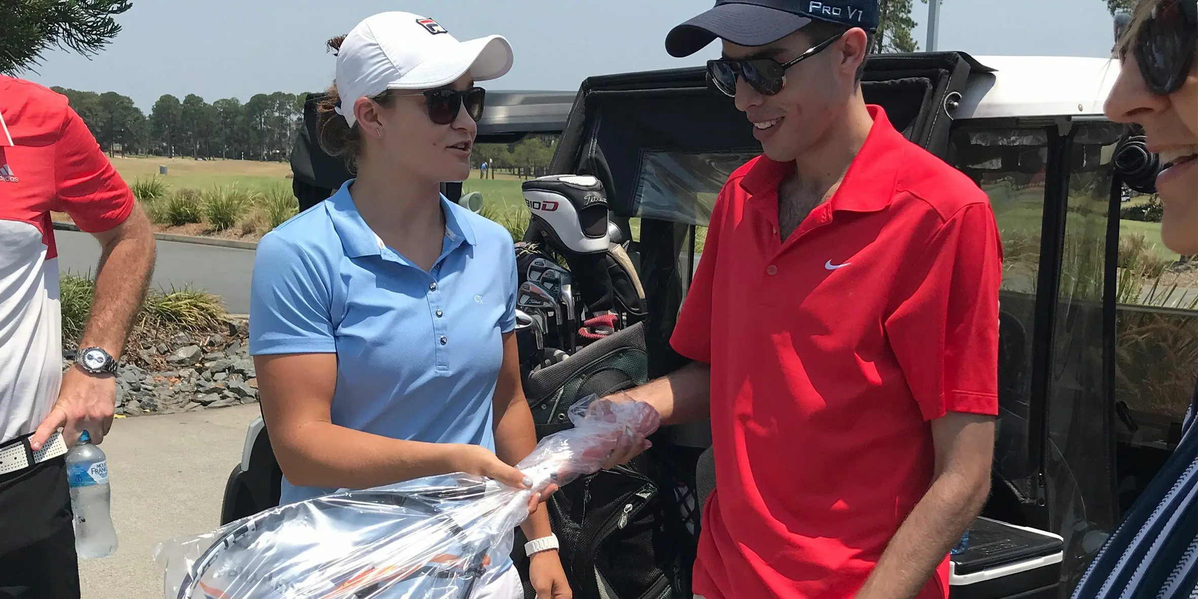 Make-A-Wish Australia wish kid George being presented with Ash Barty's US Open tennis racquets