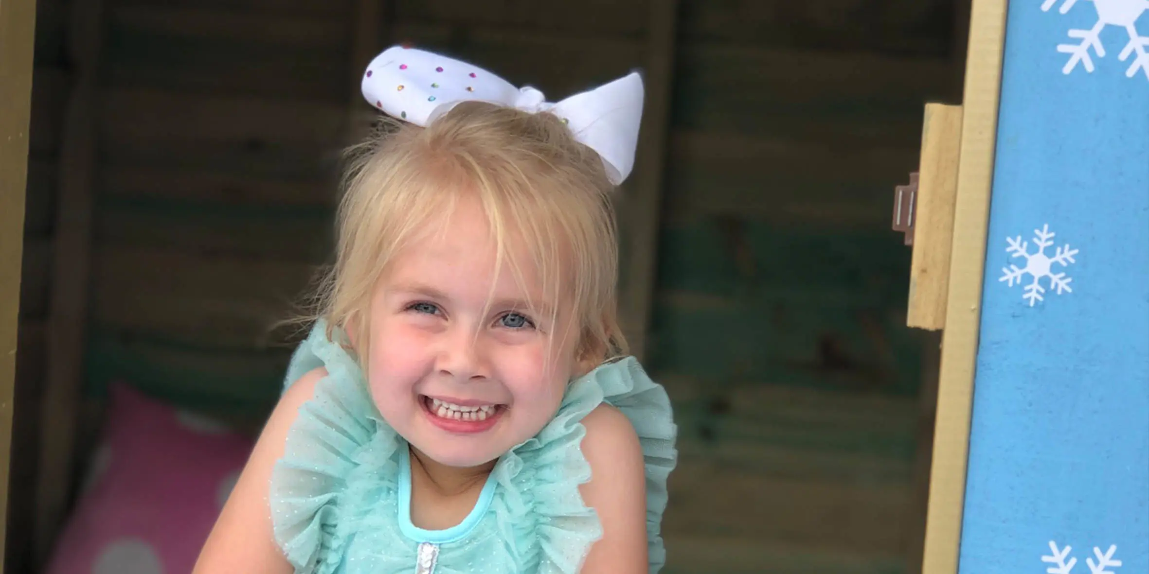 Wish Kid Penelope looks out of the cubby house on her wish