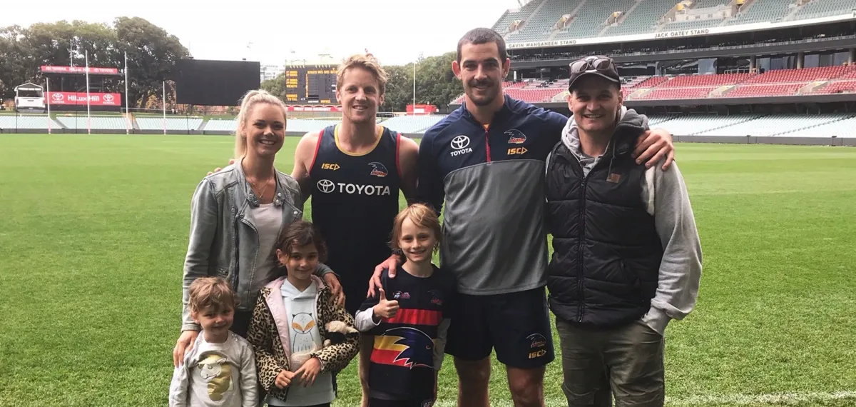 Make-A-Wish Australia wish kid Sullivan with Adelaide Crows footy players and family