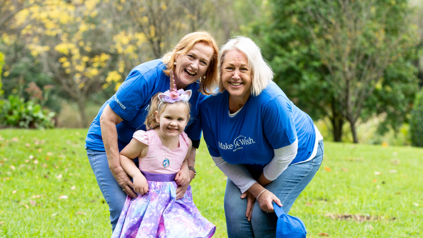 Make-A-Wish Australia event volunteer at a World Wish Day fundraiser holding collection tins