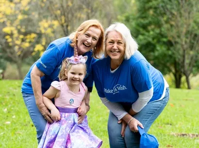 Make-A-Wish Australia event volunteer at a World Wish Day fundraiser holding collection tins