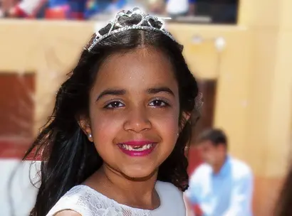 Make-A-Wish kid Priya smiles happily on her wish day to be a princess and have a tea party