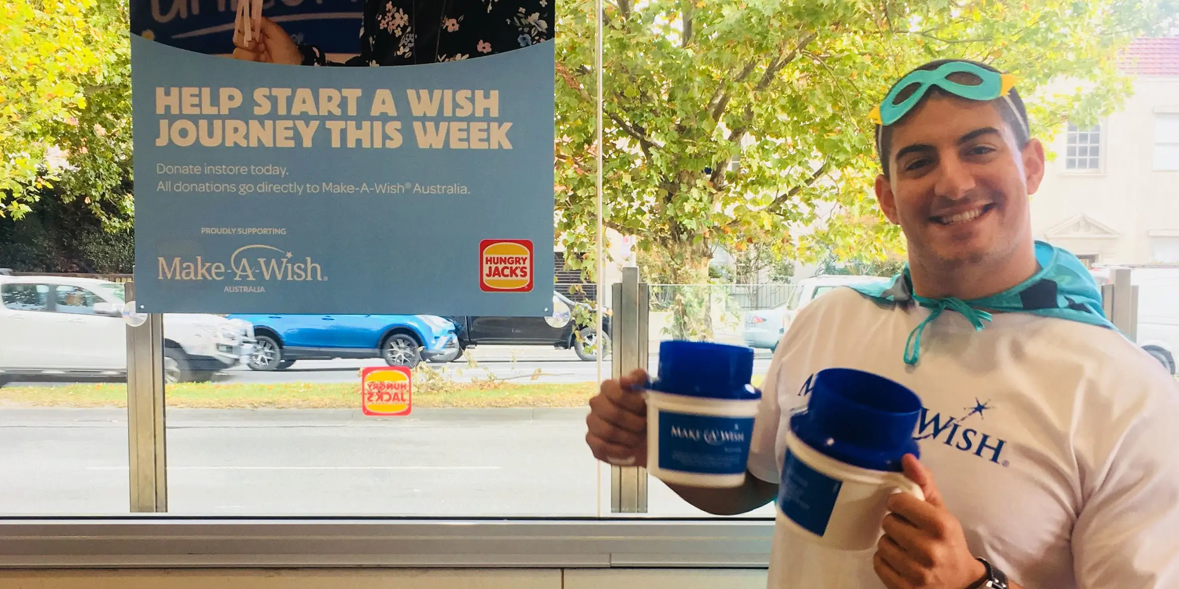 Make-A-Wish Australia event volunteer at a World Wish Day fundraiser holding collection tins