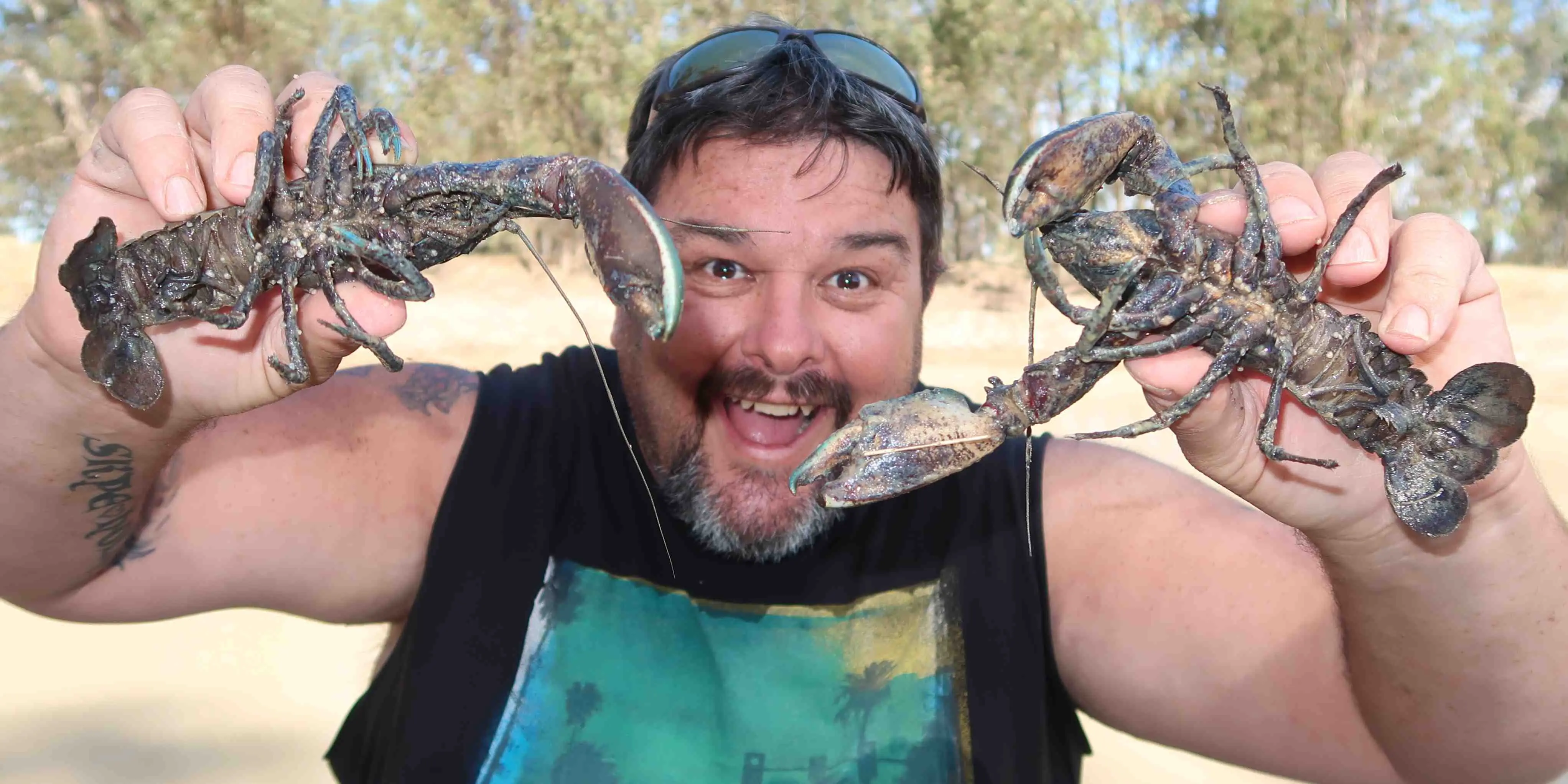 Make-A-Wish Australia volunteer Robbie holding up crayfish