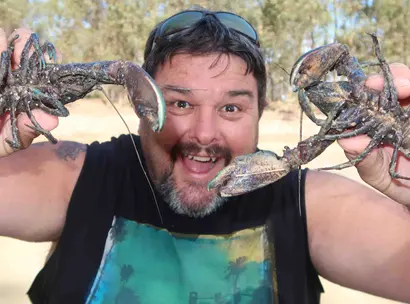 Make-A-Wish Australia volunteer Robbie holding up crayfish