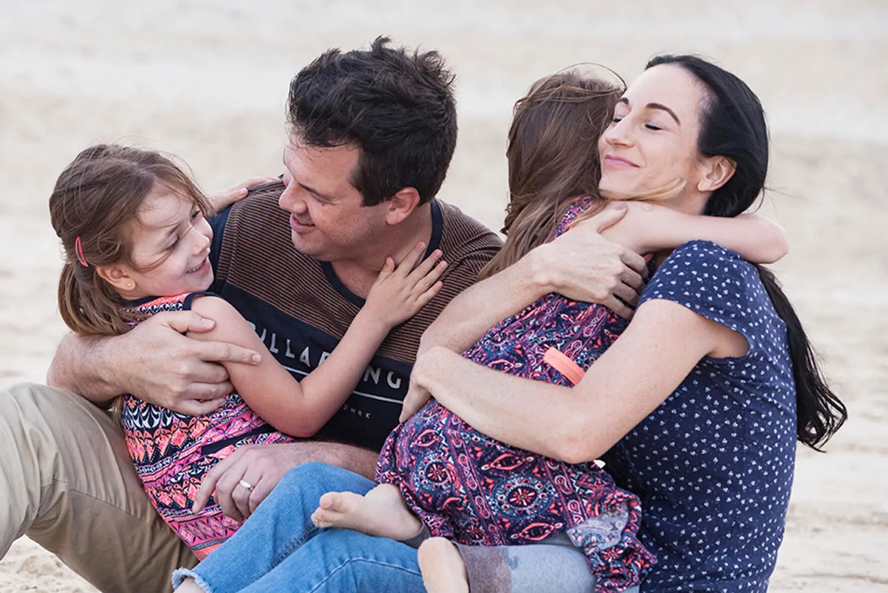 Make A Wish Australia Children's Charity - Audrey with her family hugging on the beach