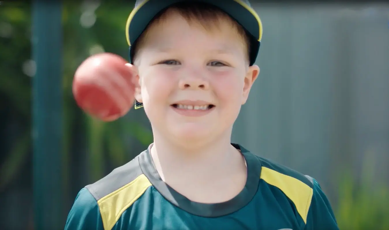 Archie tossing a cricket ball in his cricket kit