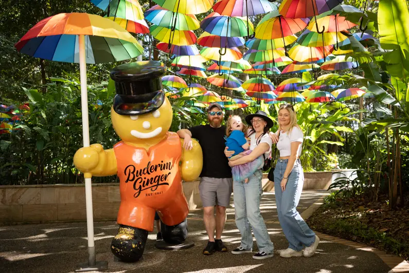 Wish child Roxy and her family stand with Ginger Bread mascot