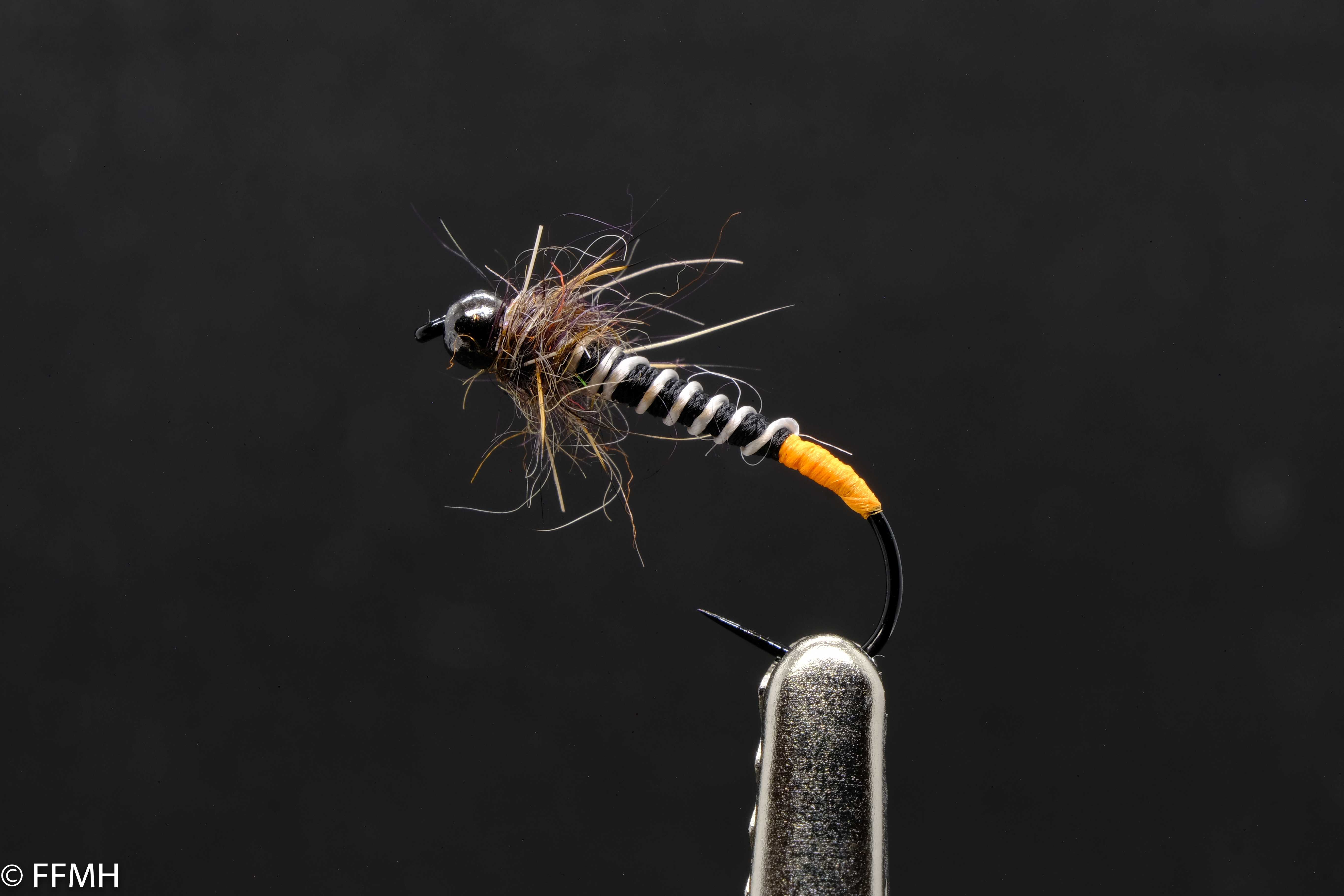 Black Head Hairy Orange Tail – handgebundene Nymphe mit schwarzem Perlenkopf, kontrastierendem, segmentiertem Körper, orangefarbenem Schwänzchen und buschigem Thorax, ideal für präzise Präsentationen in bewegtem Wasser