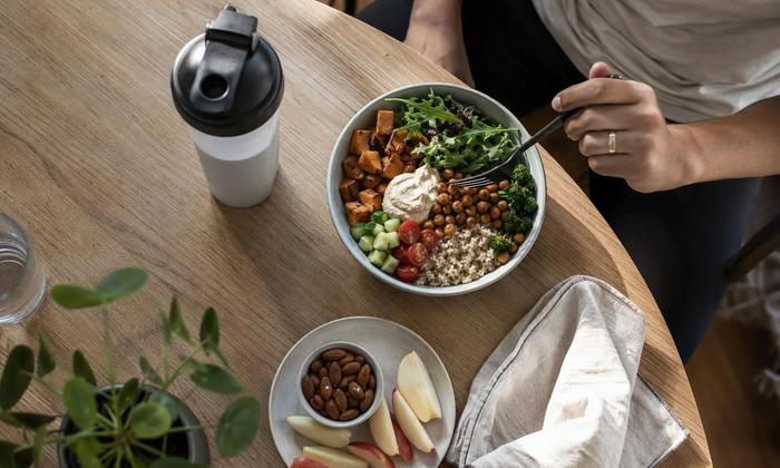 A balanced lunch, protein drink and snack arranged as eating-window options