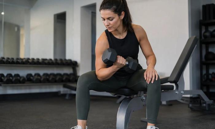 An adult performing a controlled dumbbell exercise