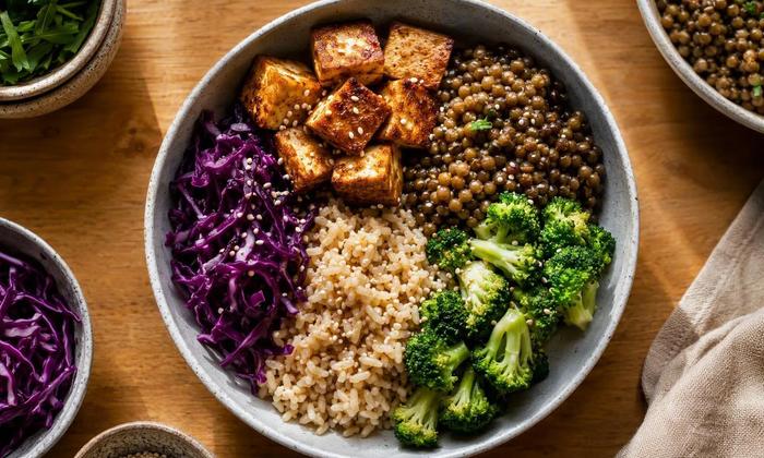 Tofu, lentils, grains and vegetables arranged for a plant-based meal