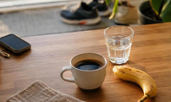 Coffee, water and a banana before a planned workout.
