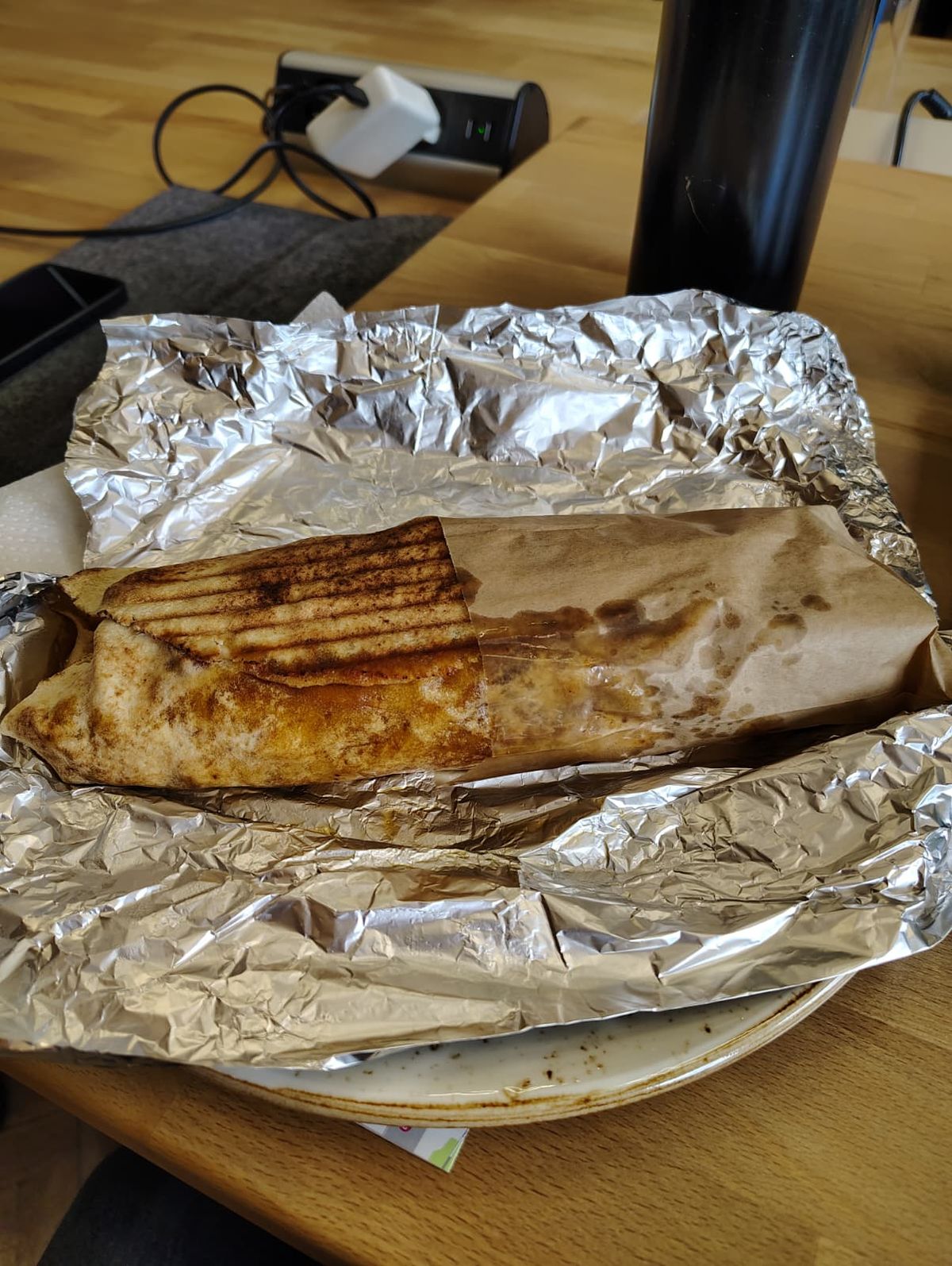 A greasy but delicious kebab sitting atop tin-foil