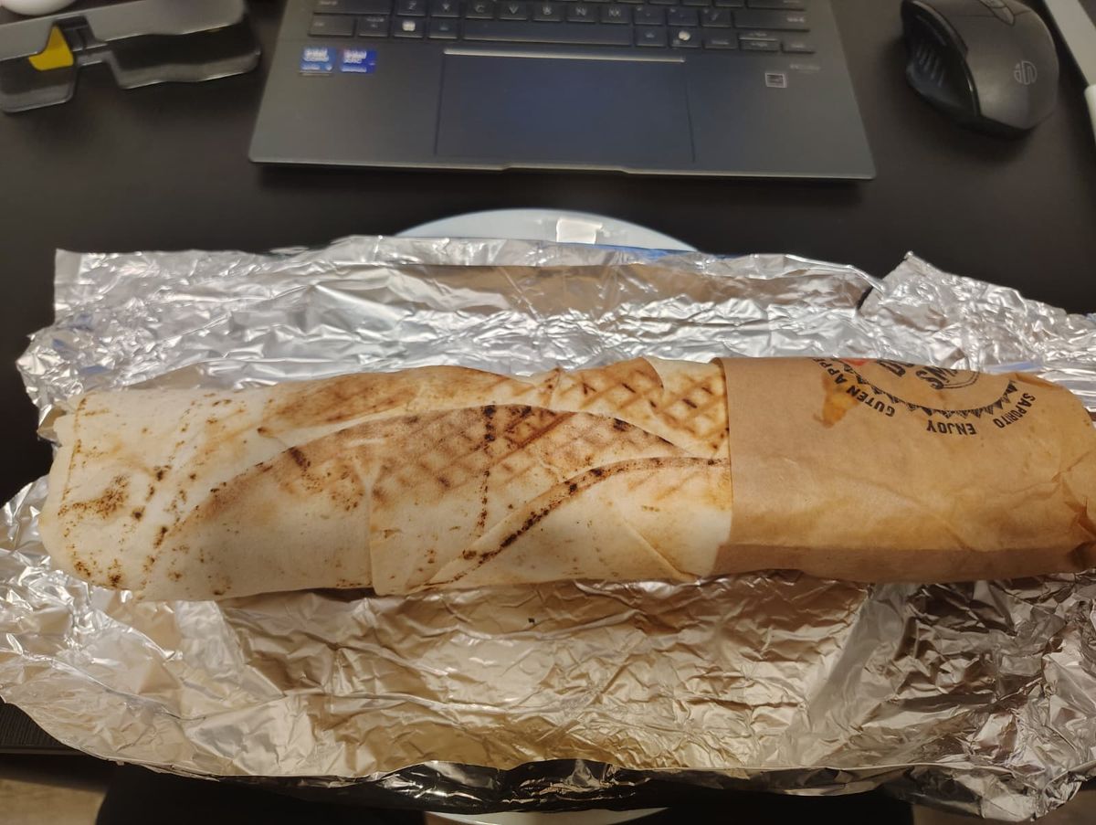 A large kebab sitting on top of tin foil