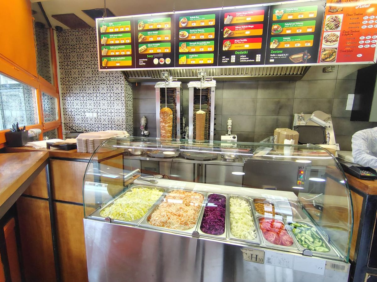 Store food counter with prices and various ingredients